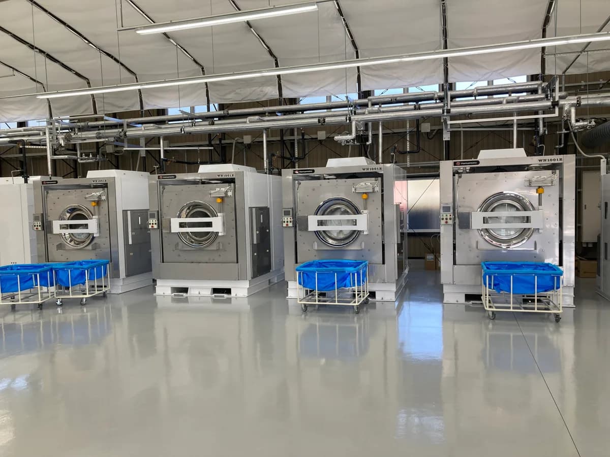 Yamamoto industrial washer-extractors with laundry carts in an on-premise laundry